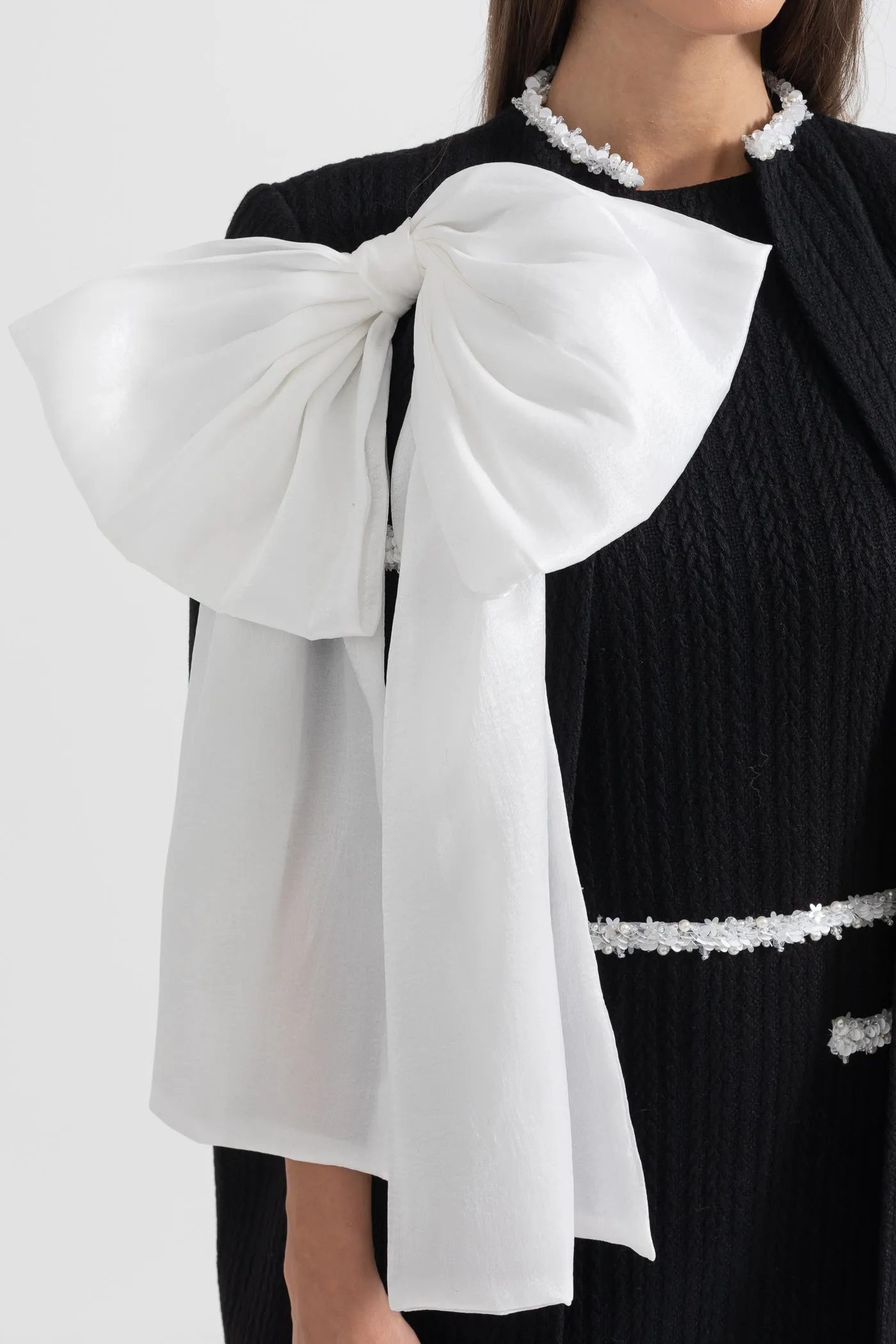 Elegant Textured Overcoat With White Bow Detail - Black